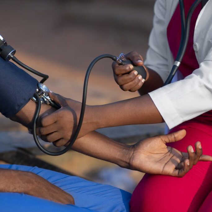 A nurse is checking a patient's blood pressure.