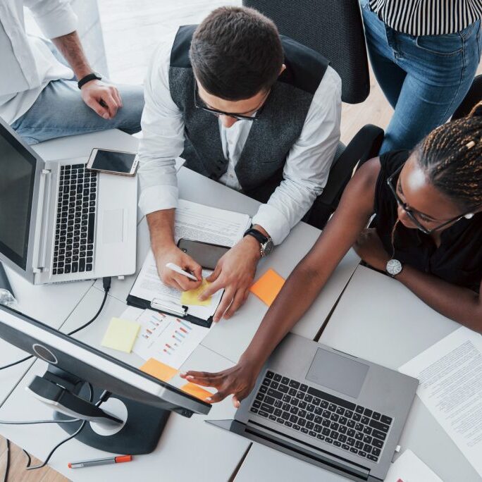 A group of people working together at a desk.